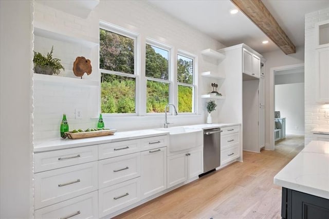 kitchen with a sink, white cabinets, dishwasher, open shelves, and tasteful backsplash