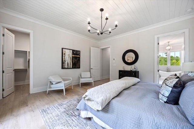 bedroom with a chandelier, light wood-style floors, baseboards, a spacious closet, and crown molding