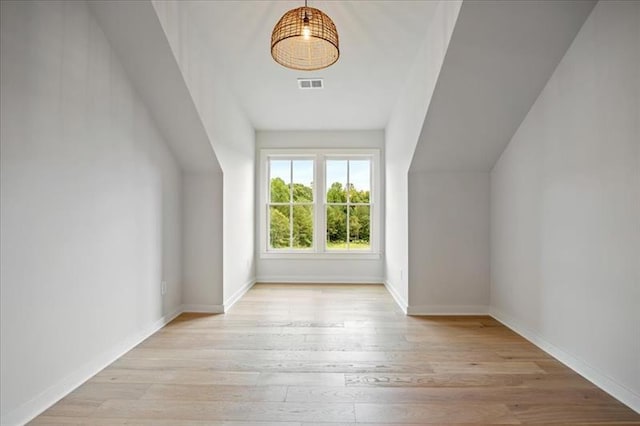 bonus room with visible vents, baseboards, and wood finished floors