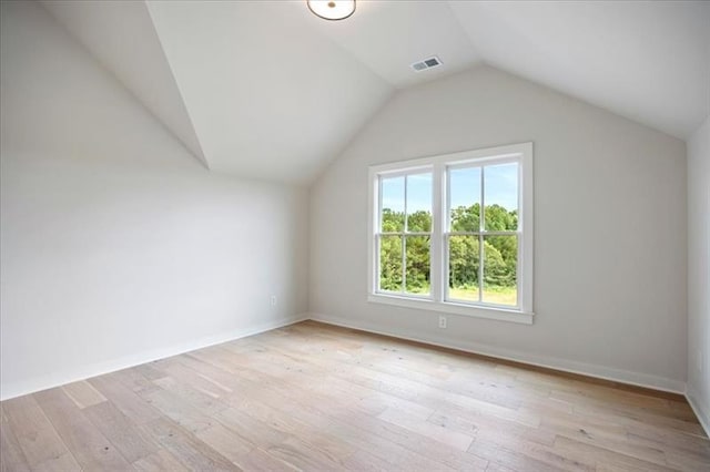 bonus room with visible vents, vaulted ceiling, light wood-style flooring, and baseboards