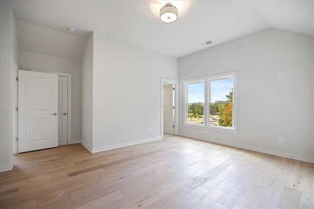 interior space with lofted ceiling, light wood finished floors, and baseboards