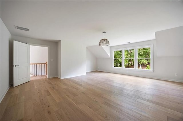 bonus room with light wood-type flooring, visible vents, and baseboards