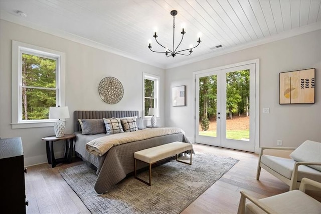 bedroom with a notable chandelier, visible vents, access to exterior, light wood finished floors, and crown molding