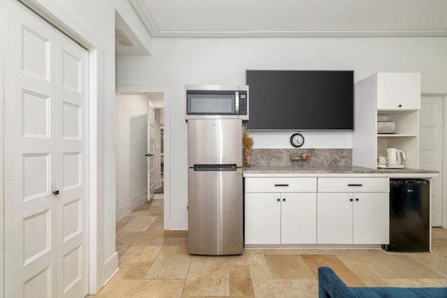 kitchen featuring appliances with stainless steel finishes and white cabinetry