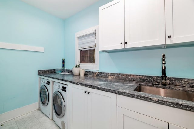 washroom with sink, cabinets, and washer and dryer