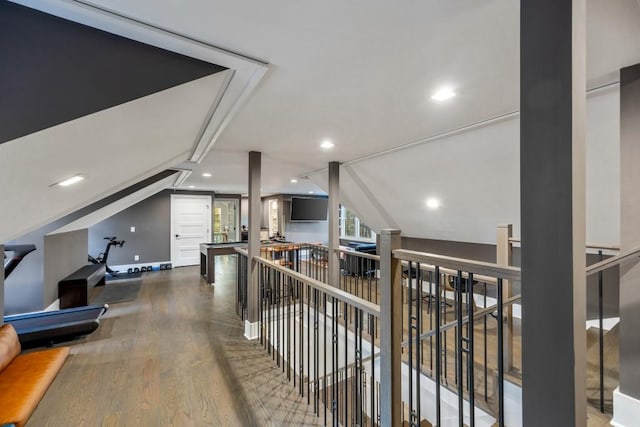 hallway featuring dark wood-type flooring and lofted ceiling