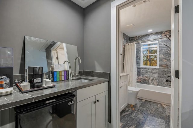 full bathroom with shower / bath combo, vanity, and toilet