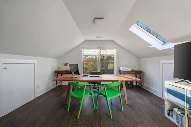 interior space with vaulted ceiling with skylight and dark hardwood / wood-style flooring