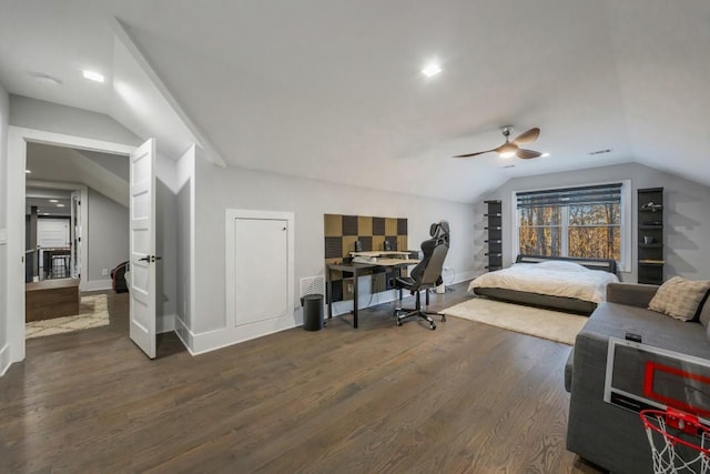 bedroom featuring dark wood-type flooring, vaulted ceiling, and ceiling fan