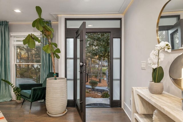 doorway featuring crown molding and dark hardwood / wood-style flooring