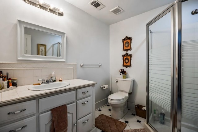 bathroom featuring toilet, a shower with door, tasteful backsplash, and vanity