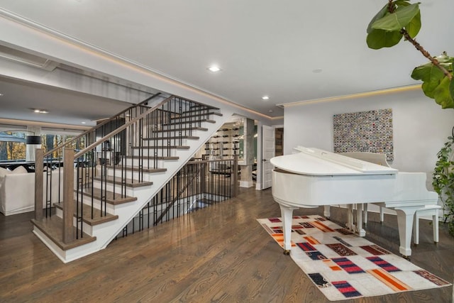 foyer featuring ornamental molding and dark hardwood / wood-style flooring