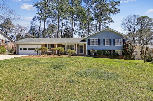 split level home with driveway, brick siding, an attached garage, and a front yard