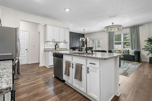 kitchen featuring pendant lighting, an inviting chandelier, white cabinets, sink, and stainless steel appliances