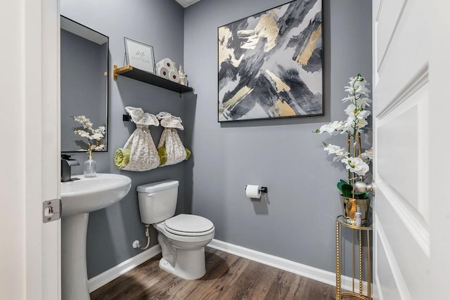 bathroom featuring toilet and hardwood / wood-style flooring