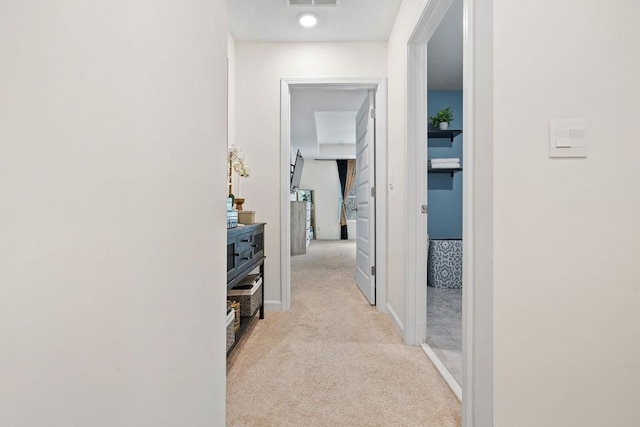 hall featuring light colored carpet