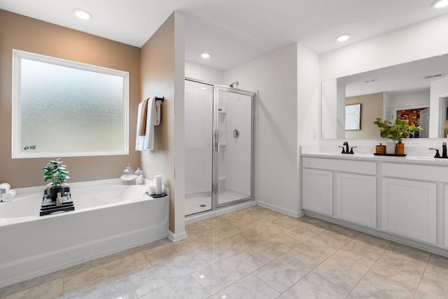 bathroom featuring vanity and plus walk in shower