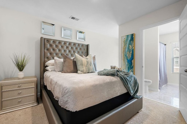 carpeted bedroom with ensuite bathroom