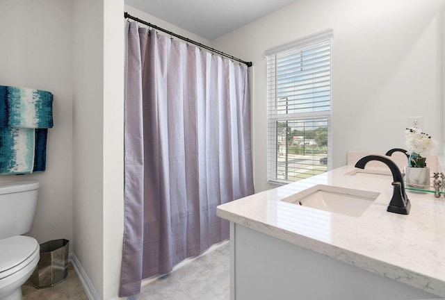 bathroom with vanity, a shower with shower curtain, and toilet