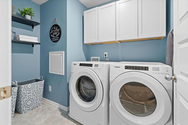 washroom featuring cabinets and independent washer and dryer