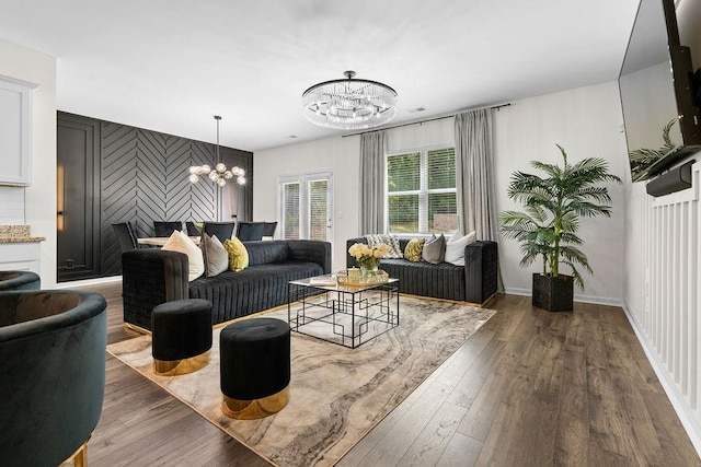 living room with dark hardwood / wood-style floors and a notable chandelier