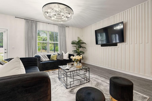 living room with hardwood / wood-style flooring and an inviting chandelier