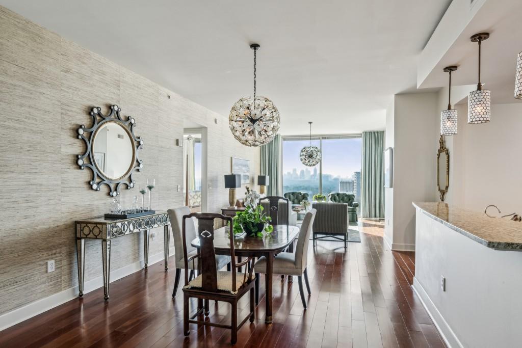 dining space with floor to ceiling windows, dark wood-type flooring, and a chandelier