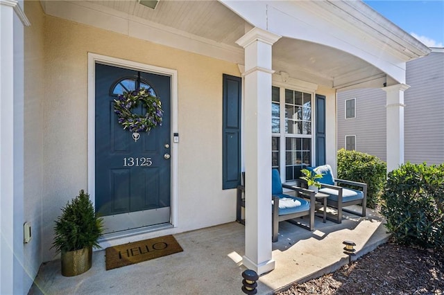 view of exterior entry with covered porch