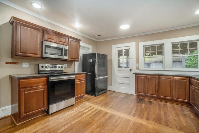 724 Bellemeade Ave NW, Atlanta, GA 30318 - kitchen with appliances with stainless steel finishes, light wood-style flooring, ornamental molding, dark countertops, and brown cabinetry