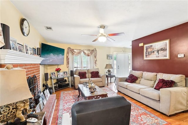 179 Parkside Dr, Stockbridge, GA 30281 - living room featuring a ceiling fan, wood finished floors, and a fireplace