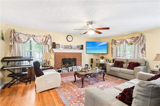 179 Parkside Dr, Stockbridge, GA 30281 - living area with plenty of natural light, ceiling fan, wood finished floors, and a brick fireplace