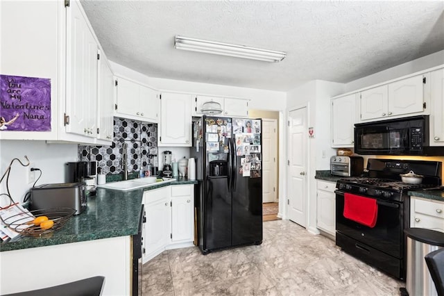 179 Parkside Dr, Stockbridge, GA 30281 - kitchen featuring black appliances, dark countertops, white cabinets, and a textured ceiling
