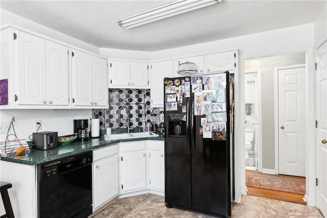 179 Parkside Dr, Stockbridge, GA 30281 - kitchen featuring black appliances, dark countertops, white cabinets, and decorative backsplash