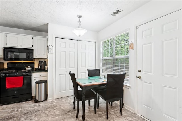 179 Parkside Dr, Stockbridge, GA 30281 - dining room featuring a textured ceiling