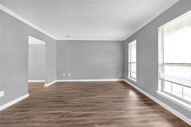 empty room featuring crown molding, dark hardwood / wood-style floors, and a textured ceiling