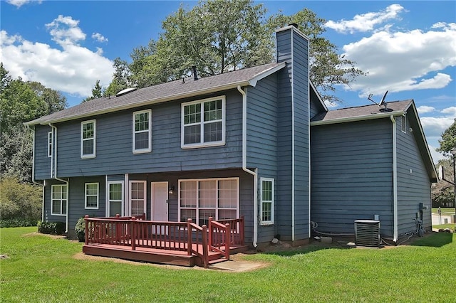 back of property featuring cooling unit, a deck, and a lawn