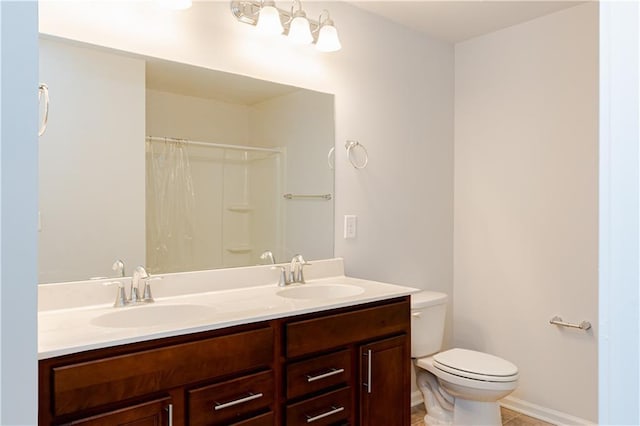 bathroom with vanity, tile patterned flooring, curtained shower, and toilet