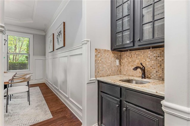 2544 Thompson Rd NE, Brookhaven, GA 30319 - bar featuring ornamental molding, a wainscoted wall, backsplash, dark wood-type flooring, and a decorative wall