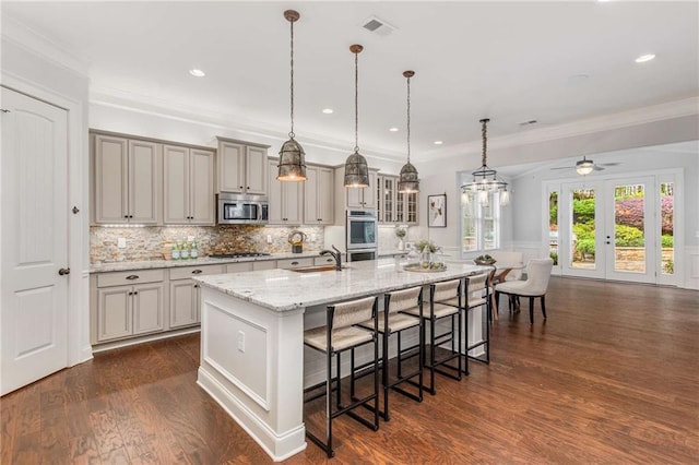 2544 Thompson Rd NE, Brookhaven, GA 30319 - kitchen featuring appliances with stainless steel finishes, a breakfast bar, decorative backsplash, a large island, and a ceiling fan