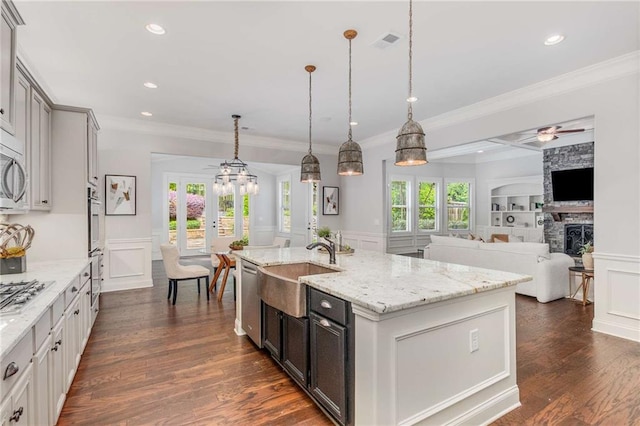 2544 Thompson Rd NE, Brookhaven, GA 30319 - kitchen with a decorative wall, a ceiling fan, a stone fireplace, appliances with stainless steel finishes, and ornamental molding