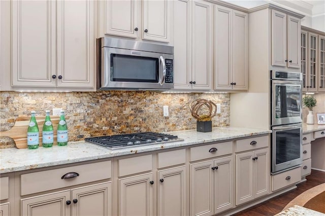 2544 Thompson Rd NE, Brookhaven, GA 30319 - kitchen with stainless steel appliances, decorative backsplash, dark wood-type flooring, and light stone countertops