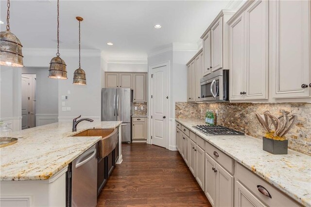 2544 Thompson Rd NE, Brookhaven, GA 30319 - kitchen with appliances with stainless steel finishes, crown molding, decorative light fixtures, dark wood finished floors, and light stone counters