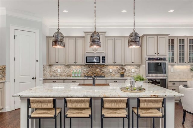 2544 Thompson Rd NE, Brookhaven, GA 30319 - kitchen featuring appliances with stainless steel finishes, a breakfast bar area, tasteful backsplash, hanging light fixtures, and light stone countertops