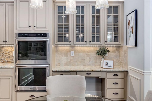 2544 Thompson Rd NE, Brookhaven, GA 30319 - kitchen with stainless steel double oven, decorative backsplash, glass insert cabinets, and decorative light fixtures
