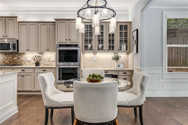 2544 Thompson Rd NE, Brookhaven, GA 30319 - dining space with dark wood-type flooring, ornamental molding, a chandelier, and wainscoting