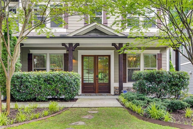 2544 Thompson Rd NE, Brookhaven, GA 30319 - doorway to property featuring french doors, a porch, and stone siding