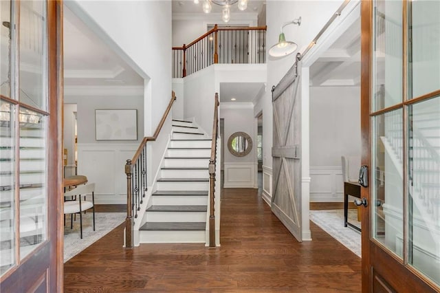 2544 Thompson Rd NE, Brookhaven, GA 30319 - entrance foyer featuring ornamental molding, a decorative wall, stairway, dark wood-type flooring, and a high ceiling