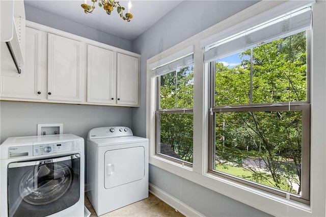 2544 Thompson Rd NE, Brookhaven, GA 30319 - laundry area featuring cabinet space, washing machine and clothes dryer, and a chandelier