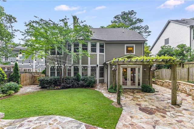 2544 Thompson Rd NE, Brookhaven, GA 30319 - back of property featuring french doors, a fenced backyard, and a patio area