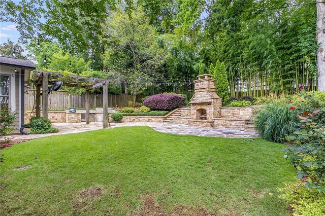 2544 Thompson Rd NE, Brookhaven, GA 30319 - view of yard featuring an outdoor stone fireplace, a pergola, and a patio